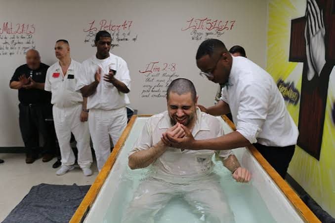 A baptism inside a prison chapel